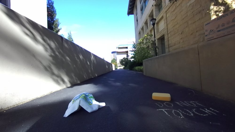 Outdoor ramp in daylight with a plastic bag and a yellow object on the path